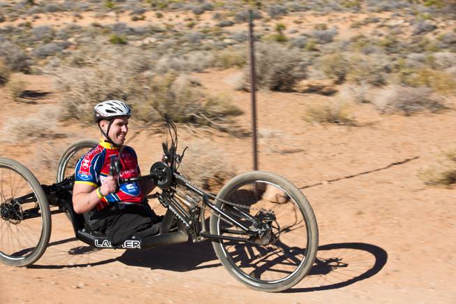 27 year-old USMC Infantryman Kevin Dubois navigates through Blue Diamond on a 3-wheel hand-powered mountain bike, built by Bill Lasher of Las Vegas, during the Ride 2 Recovery Las Vegas Mountain Bike Challenge Monday, Jan. 27, 2014. Dubois, who lost both legs during a roadside bomb attack in Afghanistan in Oct. of 2011, is among many wounded veterans who are being helped by Ride 2 Recovery, a nonprofit organization that provides rehabilitation to injured veterans through cycling.